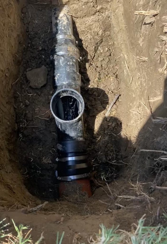 Plumber from PBT – Plumbing by Tony performing efficient drain cleaning in a home.