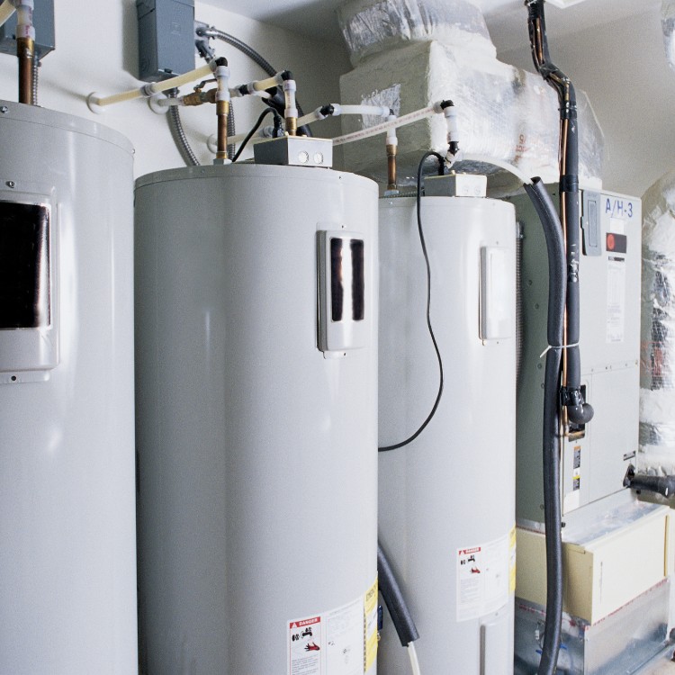 Tankless water heaters installed in a residential setting, showcasing plumbing services by Plumbing By Tony.