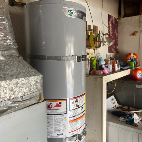 Plumbing By Tony Water heater installation by AO Smith in a utility room, showcasing plumbing equipment and cleaning supplies, relevant to Plumbing By Tony's water service solutions.